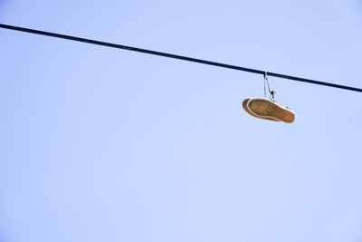 Low angle view of cables against clear blue sky