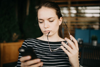 Midsection of man using mobile phone