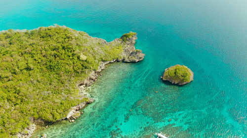 Turquoise lagoon with rocky island and corall reef, aerial view boracay, philippines. 