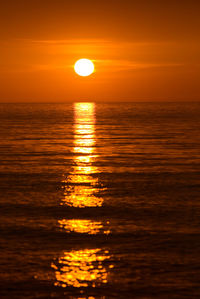 Scenic view of sea against romantic sky at sunset