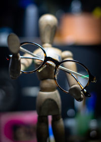 Close-up of eyeglasses on figurine
