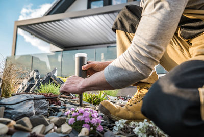 Mature man with equipment working in garden