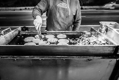 Midsection of man working at dusk