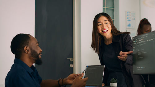 Side view of young businesswoman working at office