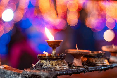 Close-up of lit candles in temple