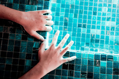 Cropped hands in swimming pool