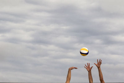 Low angle view of person playing ball against sky