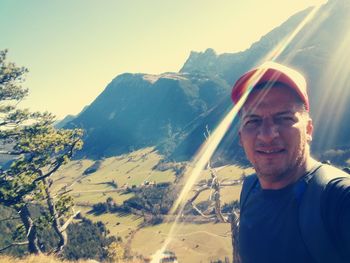 Portrait of smiling man on mountain against sky