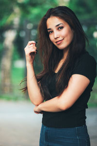 Portrait of beautiful young woman standing outdoors