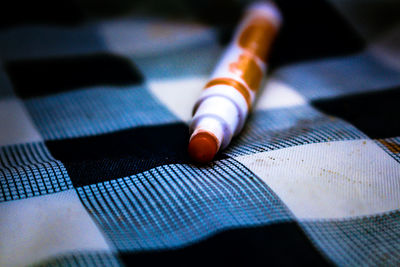 Close-up of pen on textile