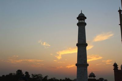Low angle view of tower against sky during sunset