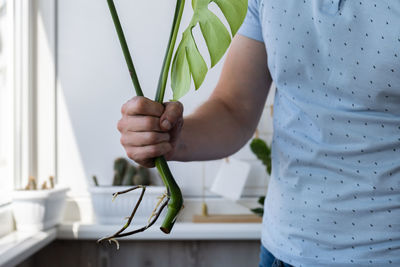 Midsection of man holding rope