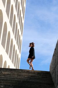 Low angle view of woman walking on steps