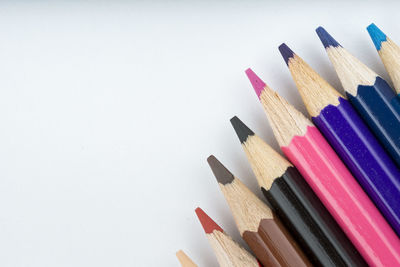 Close-up of colored pencils against white background