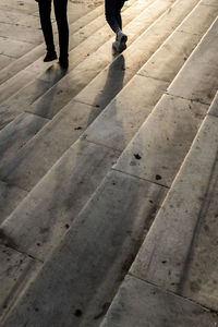 Low section of people walking on footpath