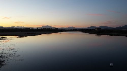 Scenic view of lake against sky during sunset