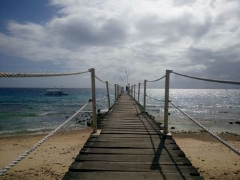 Pier over sea against sky