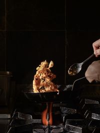 Person preparing food on barbecue grill