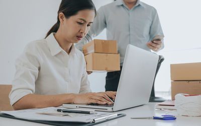 Young woman using laptop on table