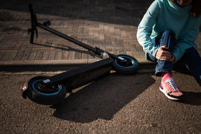 Low section of woman fell from push scooter