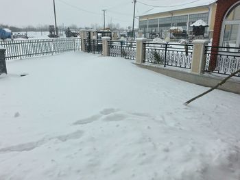 Snow covered built structure against sky