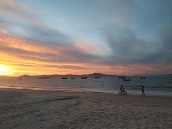 Scenic view of beach against sky during sunset