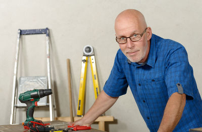 Portrait of mature man standing in workshop