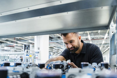 Engineer checking electrical equipment at automated industry