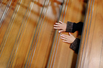 High angle view of person playing piano