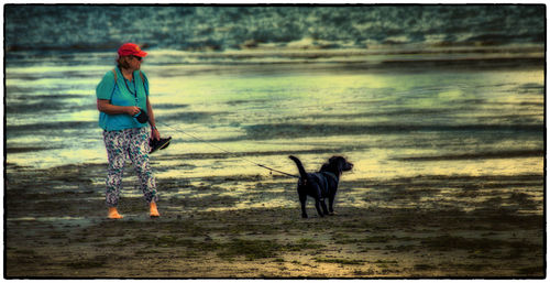 Full length of woman standing on beach