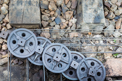 High angle view of metallic wheels on rods