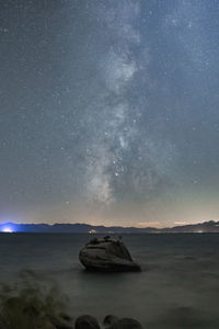 Scenic view of sea against sky at night