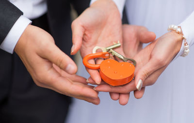 Close-up of young couple with padlock