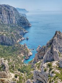 High angle view of rocks by sea against sky