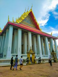 People at temple against building