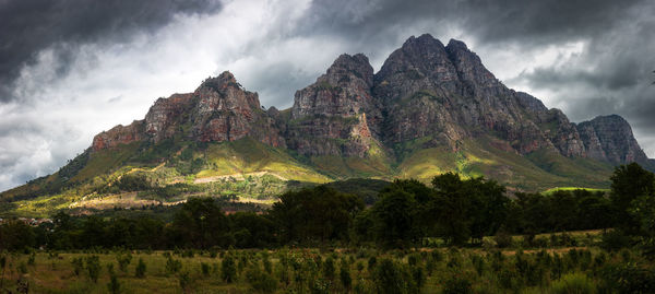 A mountain in stellenbosch, near cape town famous for the production of wine, hit by shafts of light