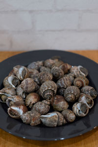 High angle view of shells in plate on table