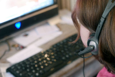 Woman wearing headset and using computer