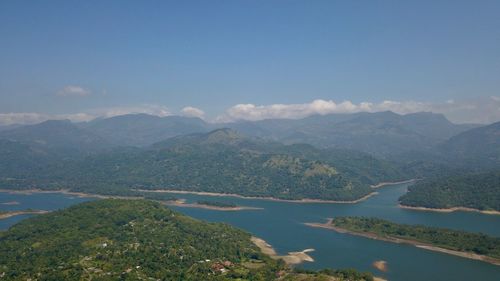 Scenic view of river and mountains against sky