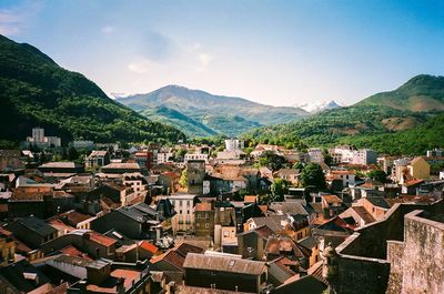 Congested houses with mountains against sky