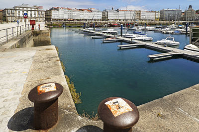 Close-up of pier at harbor against sky