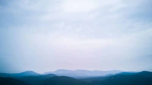 Scenic view of silhouette mountains against sky