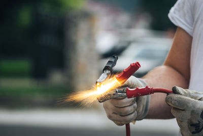 Midsection of man working on fire