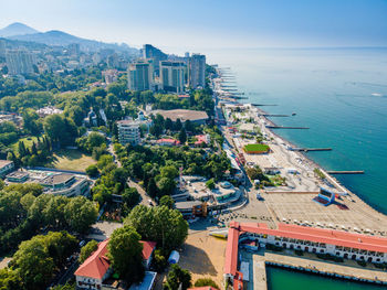 High angle view of buildings by sea against sky