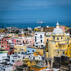 High angle view of townscape by sea against sky