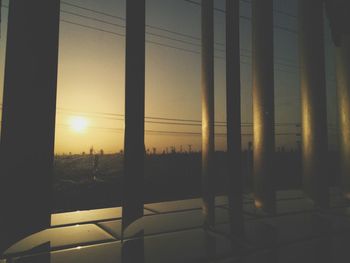 Close-up of illuminated lamp at sunset