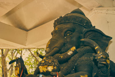 Close-up of statue against building