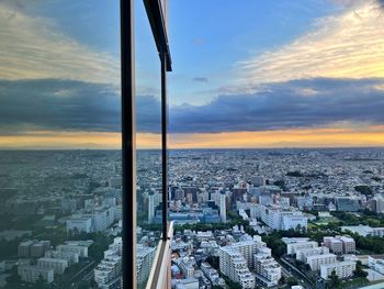High angle view of city buildings against sky during sunset