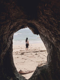 Rear view of man walking in cave