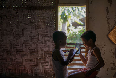 Children standing against wall